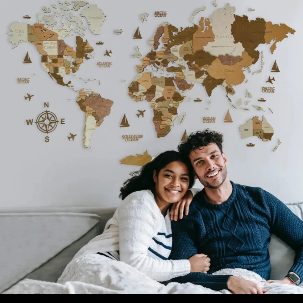 Couple pointing at wooden world map